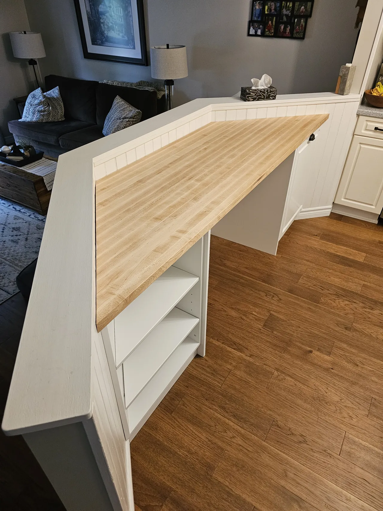 Open shelf end panel on a custom maple topped desk